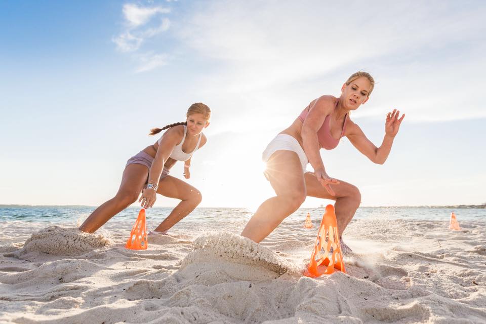 Two women exercising on the beach in Pensacola Beach, Florida.