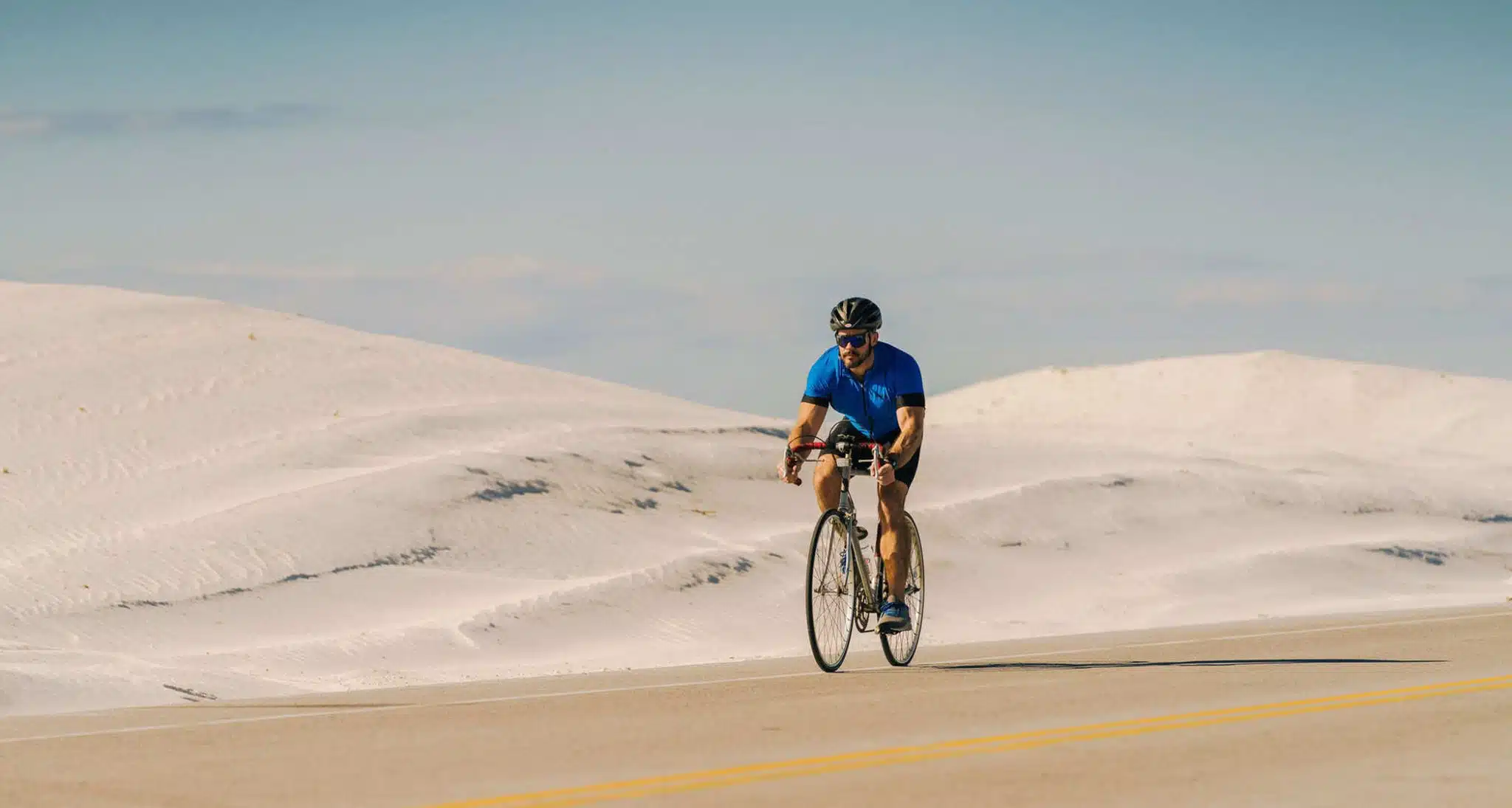 Cyclist on the road along Pensacola Beach, Florida.