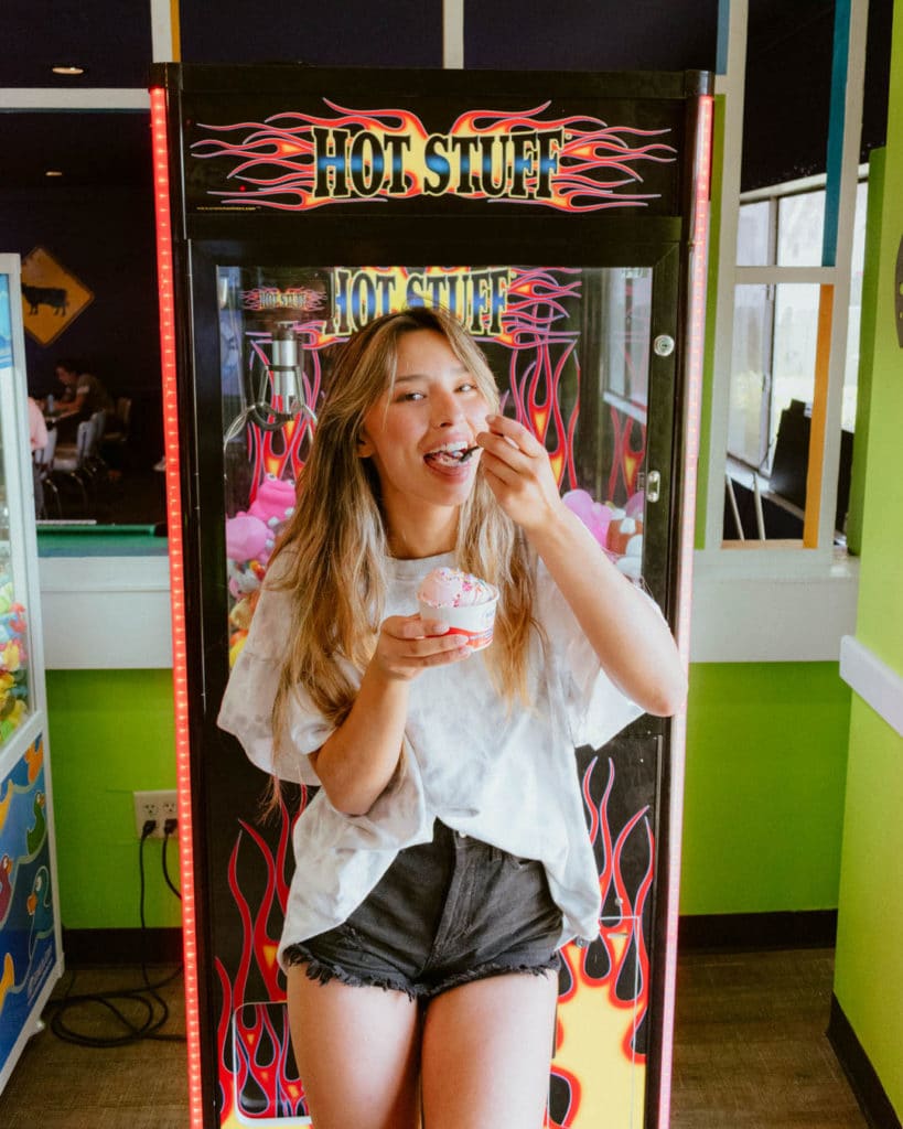 Girl eating ice cream from UFO's in Pensacola Beach.