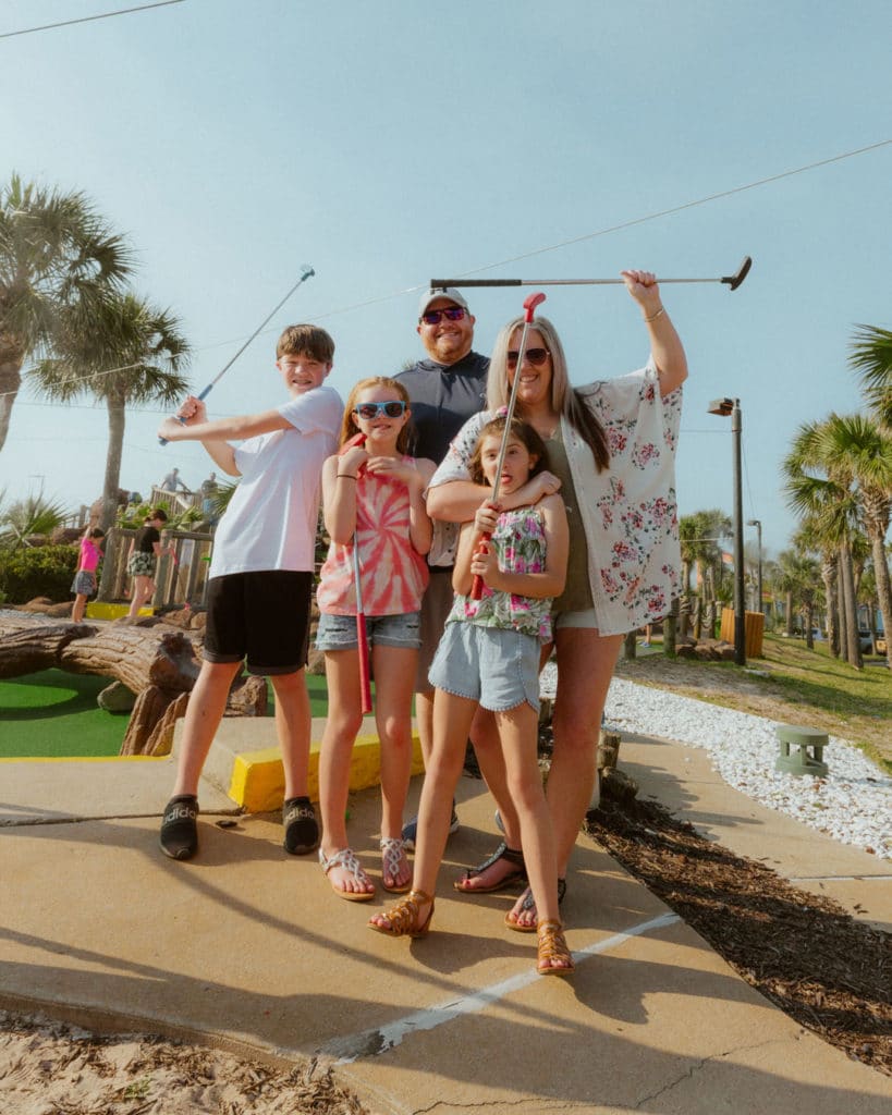 Family mini golfing in Pensacola Beach.