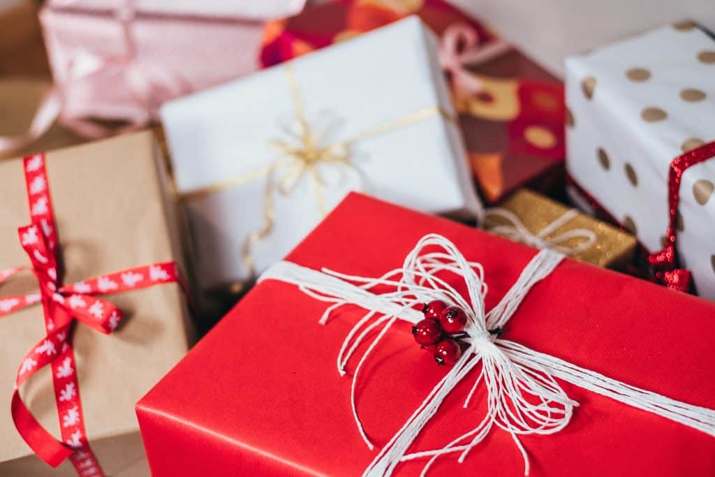 Christmas gifts wrapped in bows and wrapping paper.
