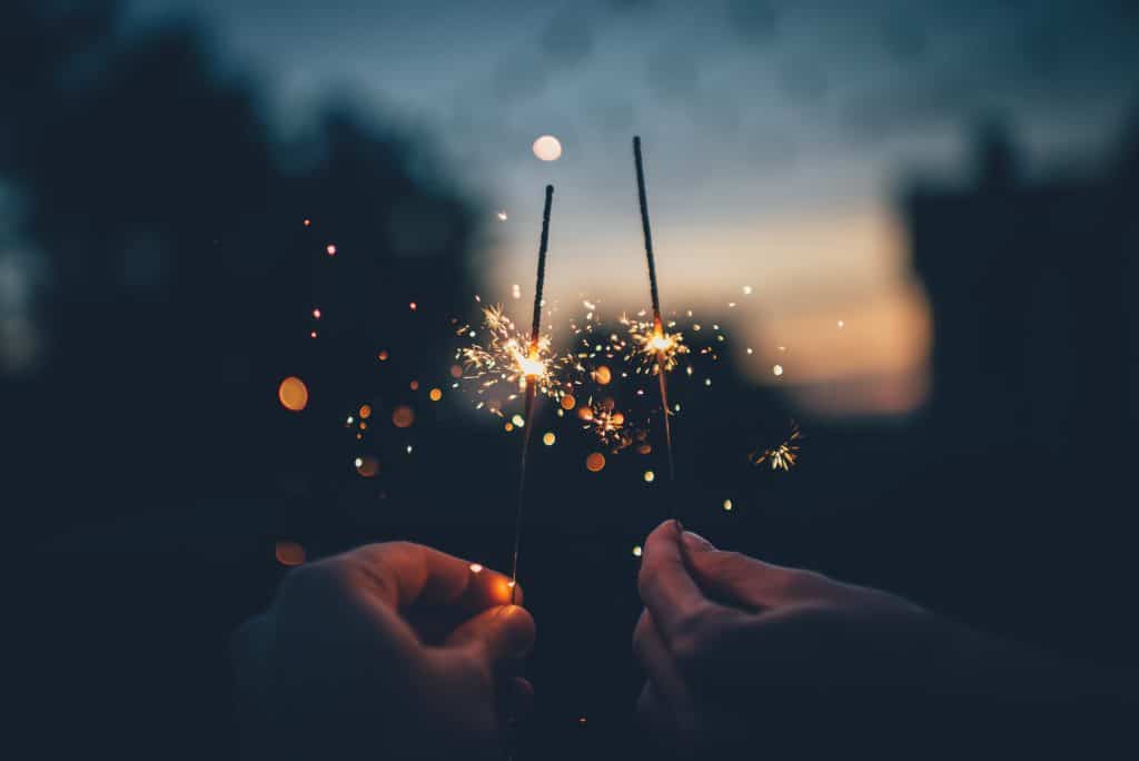 Person holding sparklers.